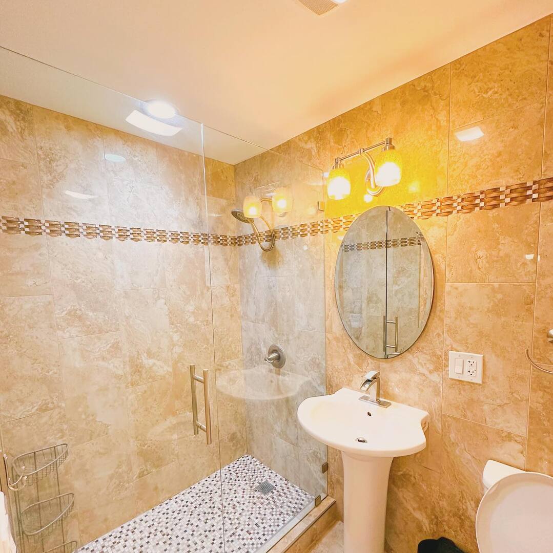 1575 Sandpebble Drive, Unit 104 Wheeling, IL 60090 - Photo 7 of 8 a bathroom with a sink mirror and shower