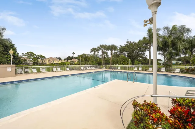 a view of a swimming pool and lake from nearby houses