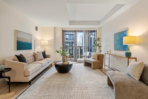 a living room with furniture and a rug