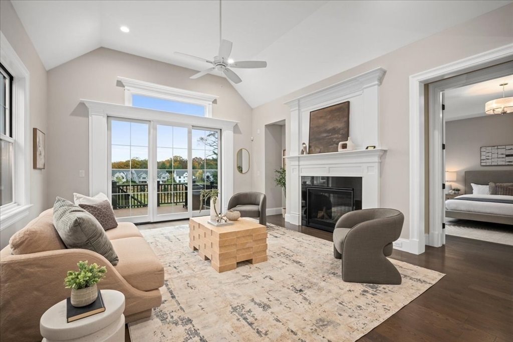 9 Hawk Lane, Unit 28 Framingham, MA 01701 - Photo 11 of 37 a living room with furniture a fireplace and large windows