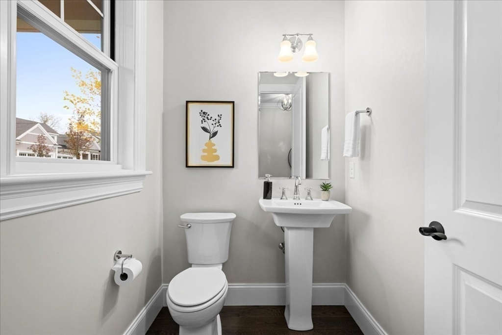 9 Hawk Lane, Unit 28 Framingham, MA 01701 - Photo 19 of 37 a bathroom with a toilet a sink and mirror