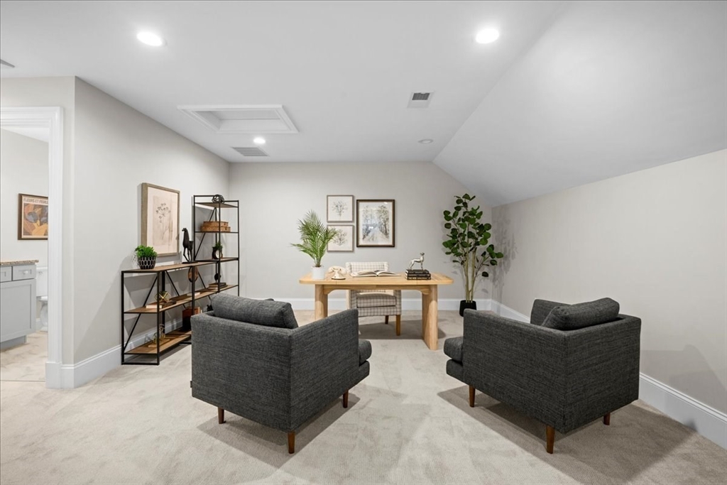 9 Hawk Lane, Unit 28 Framingham, MA 01701 - Photo 23 of 37 a living room with furniture and a potted plant