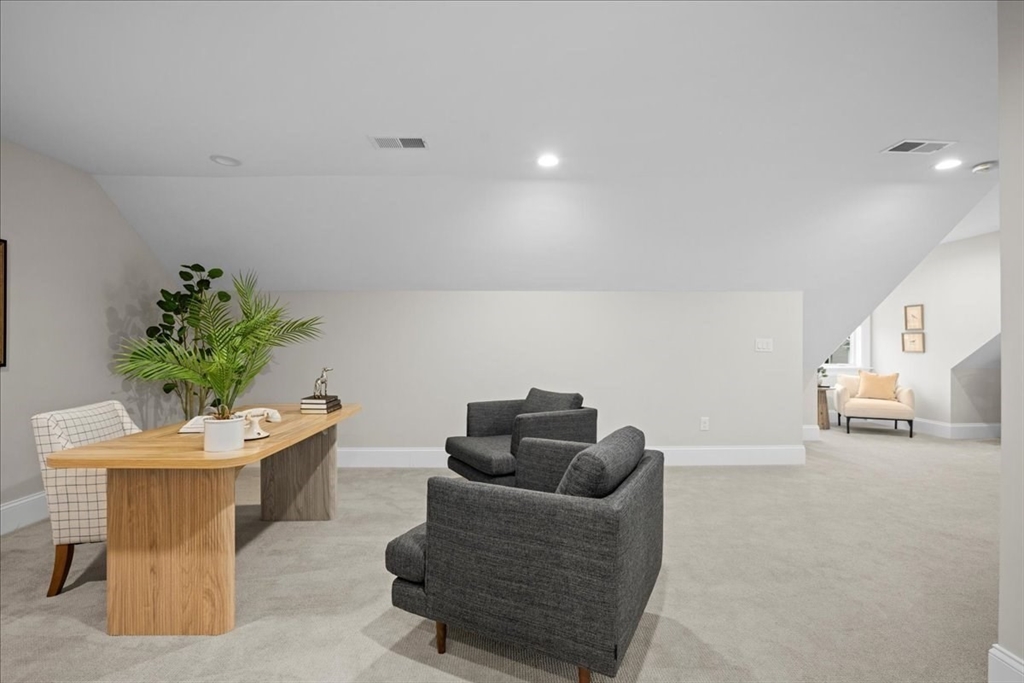 9 Hawk Lane, Unit 28 Framingham, MA 01701 - Photo 24 of 37 a living room with furniture and a potted plant