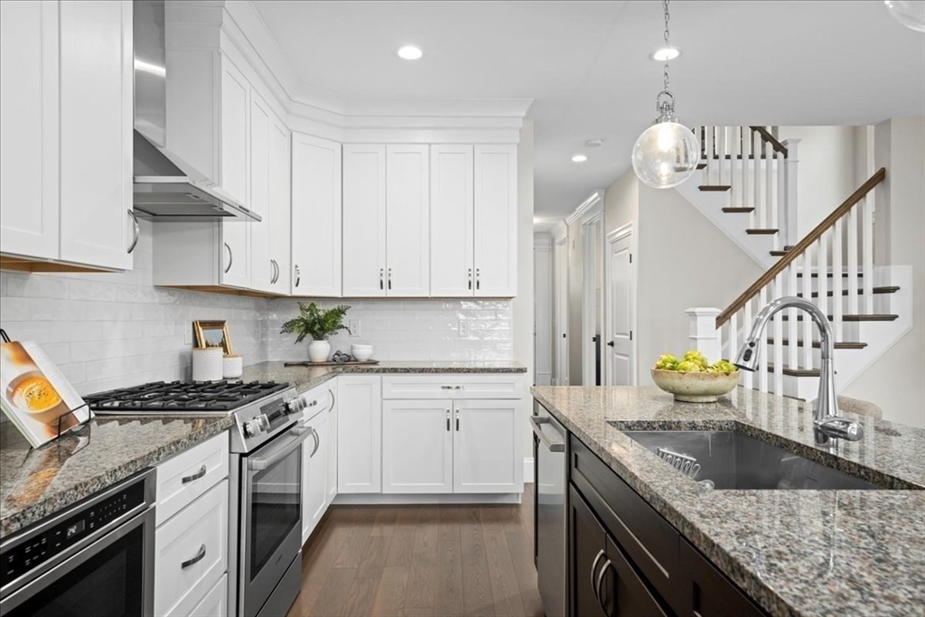 9 Hawk Lane, Unit 28 Framingham, MA 01701 - Photo 5 of 37 a kitchen with granite countertop a sink a stove and cabinets