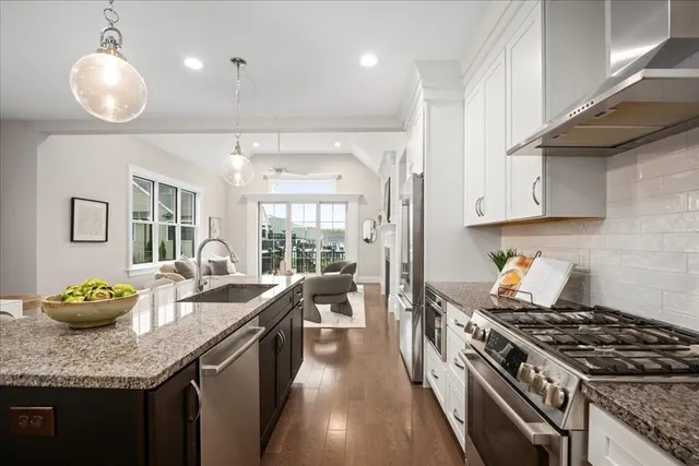 a kitchen with granite countertop lots of counter top space and stainless steel appliances