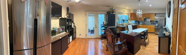 a view of a hallway with furniture and a chandelier