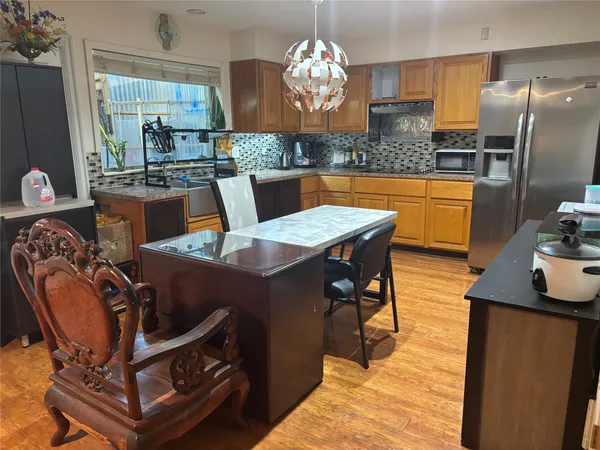 a view of a dining room with furniture a chandelier and wooden floor