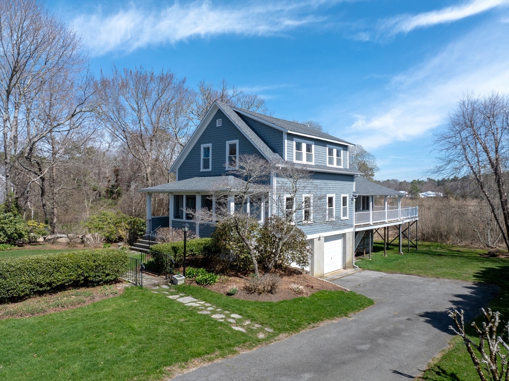 329 Front Street Marion, MA 02738 - Photo 1 of 42 a front view of a house with a garden