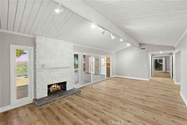 a view of wooden floor and windows in a room