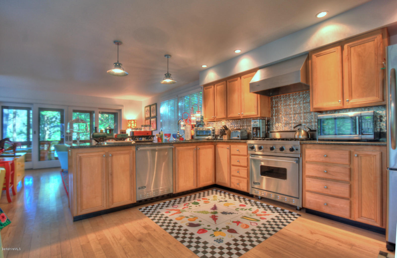 34 Bidwell Road Monterey, MA 01245 - Photo 13 of 37 a kitchen with stainless steel appliances granite countertop a refrigerator a sink dishwasher a stove and white countertops with wooden floor