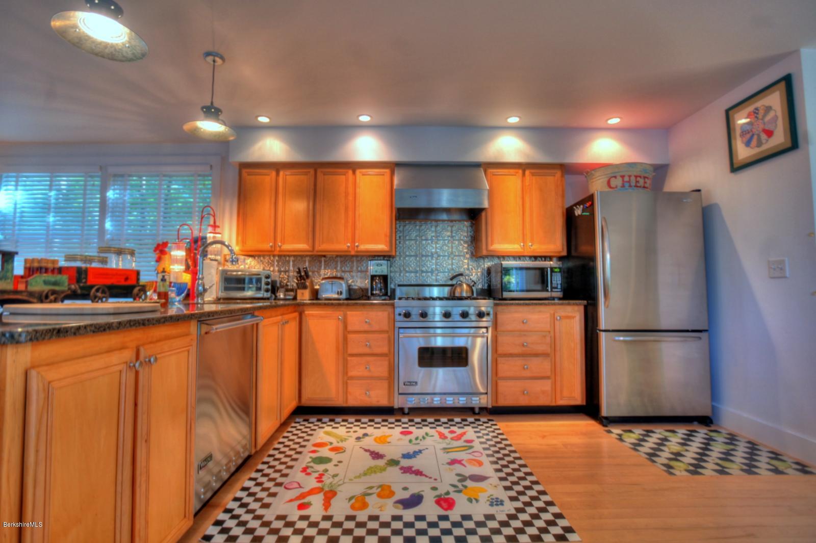 34 Bidwell Road Monterey, MA 01245 - Photo 14 of 37 a kitchen with stainless steel appliances granite countertop a refrigerator a stove a sink and a microwave