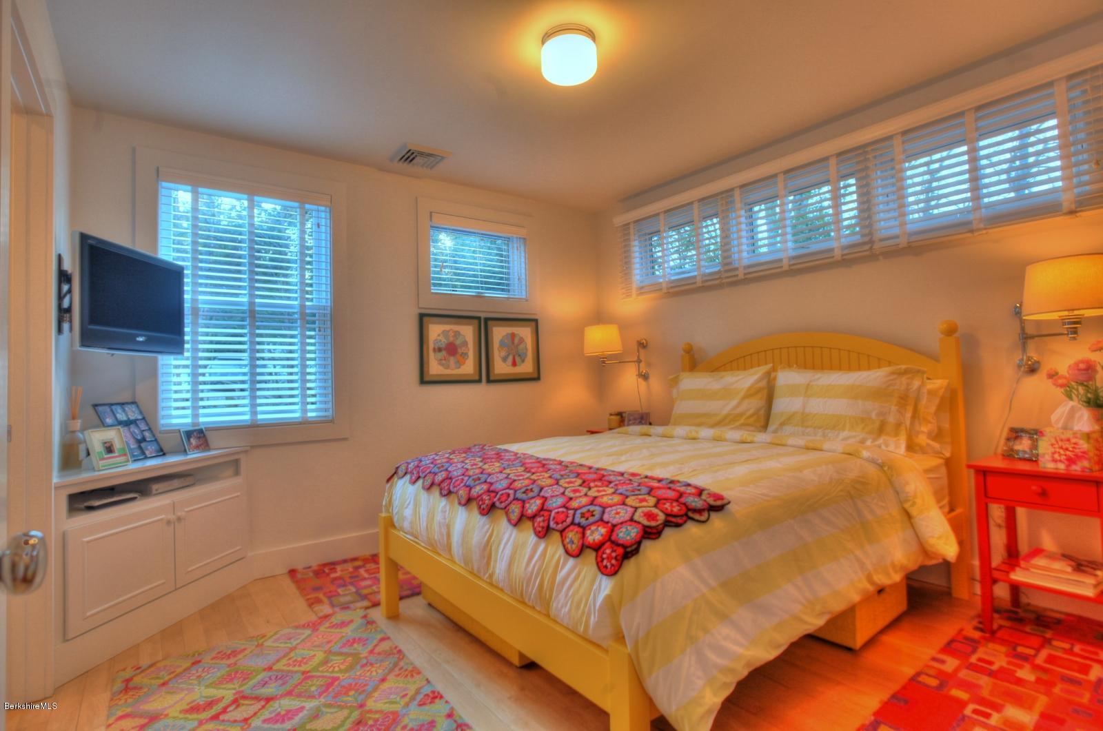 34 Bidwell Road Monterey, MA 01245 - Photo 22 of 37 a bedroom with a bed and a large window