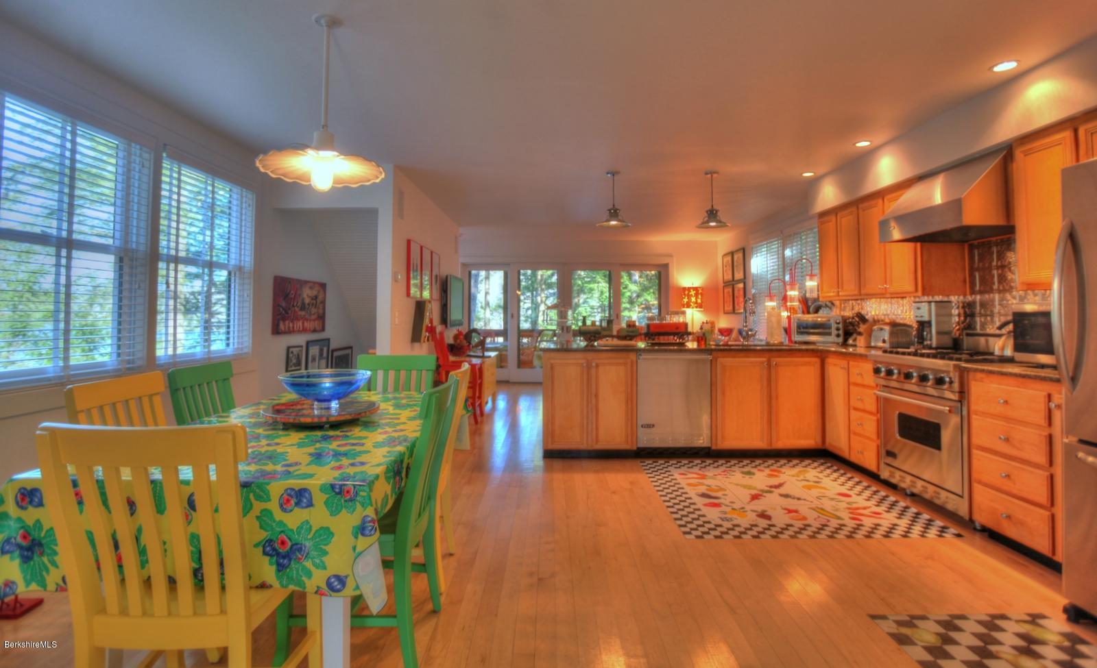 34 Bidwell Road Monterey, MA 01245 - Photo 8 of 37 a view of a kitchen with kitchen island stainless steel appliances wooden floor and a large window