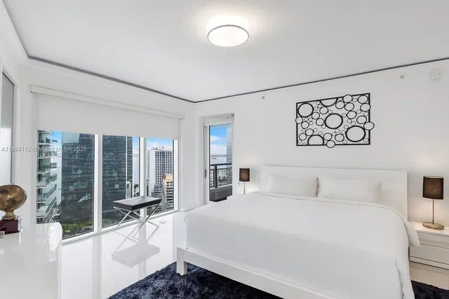 a bedroom with a large bed and a large window