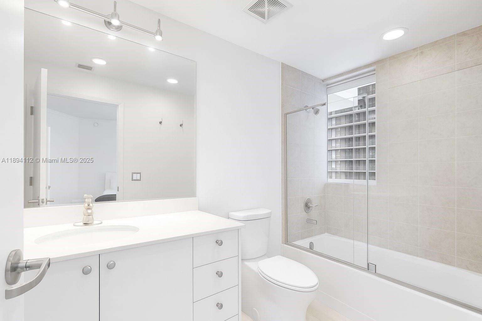 60 Southwest 13th Street, Unit 2500 Miami, FL 33130 - Photo 6 of 18 a bathroom with a sink a toilet and shower