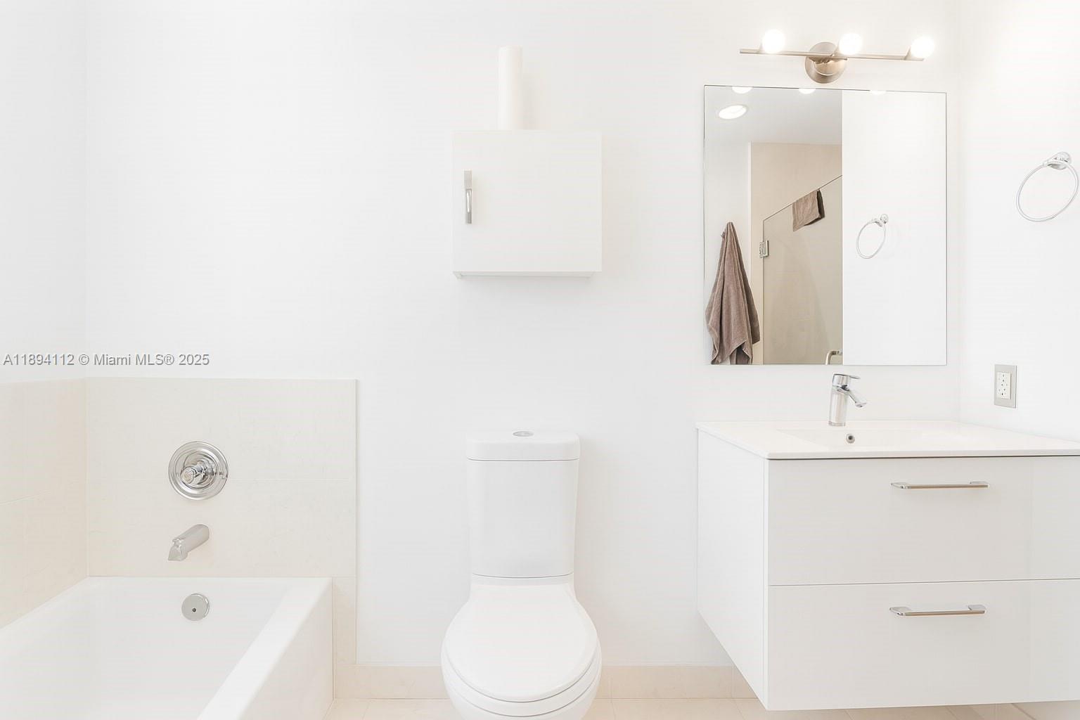 60 Southwest 13th Street, Unit 2500 Miami, FL 33130 - Photo 8 of 18 a bathroom with a sink a toilet and shower