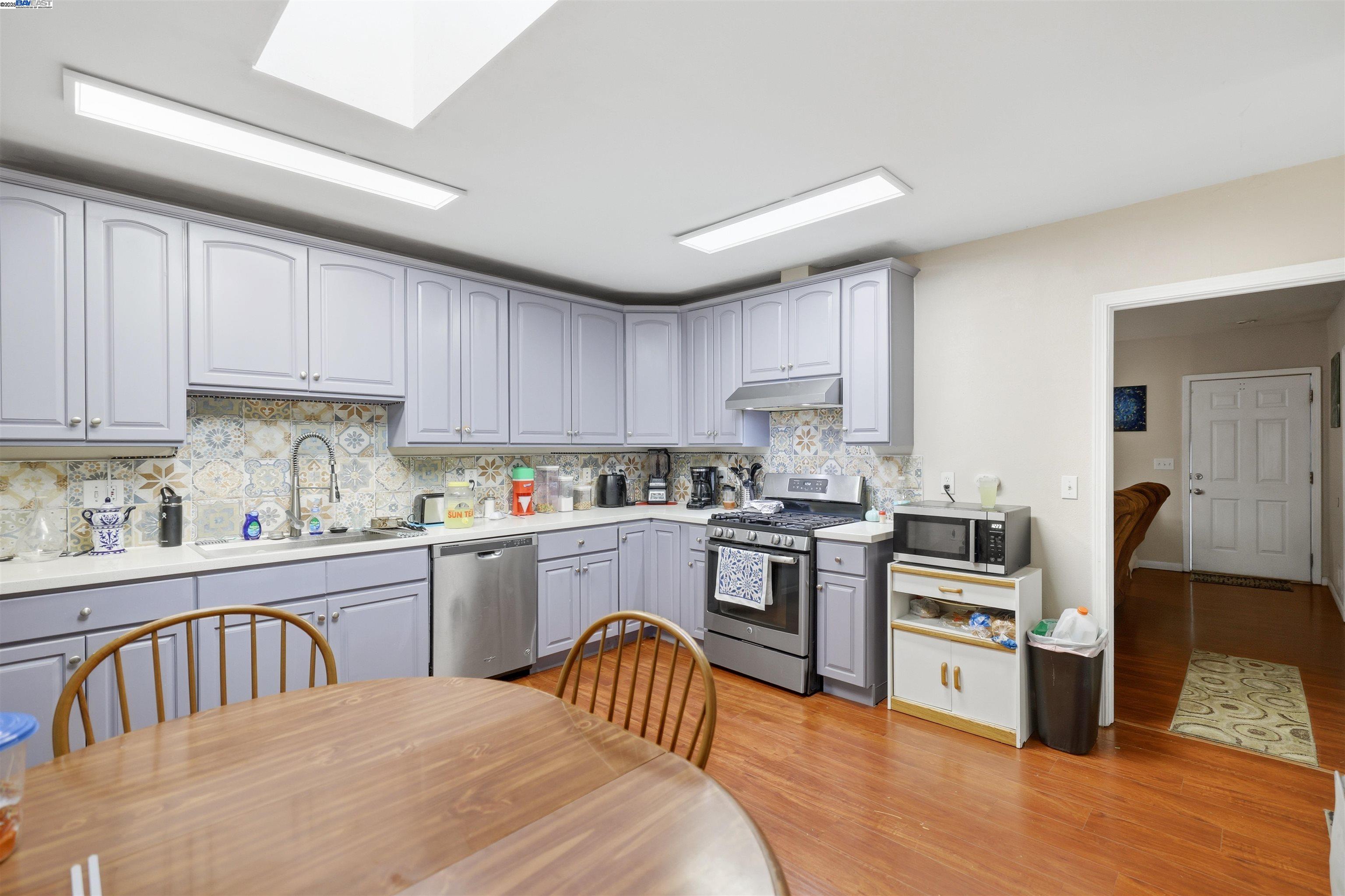 1040 Delacy Avenue Martinez, CA 94553 - Photo 12 of 52 a kitchen with stainless steel appliances sink stove microwave and cabinets
