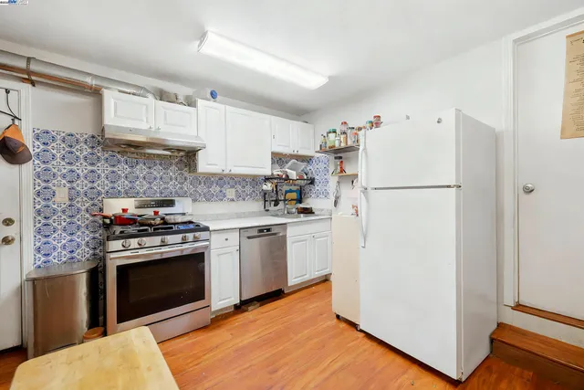 a kitchen with a stove top oven and refrigerator