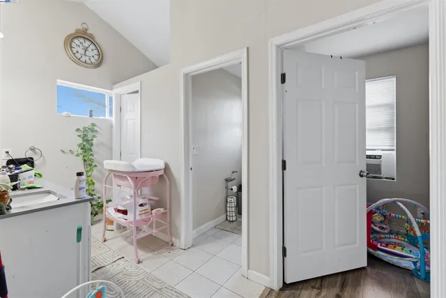 a white toilet sitting next to a white sink and vanity