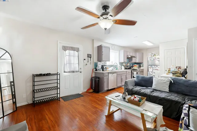 a dining room with furniture and wooden floor
