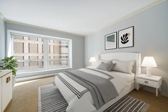 a bedroom with a large bed and a large window