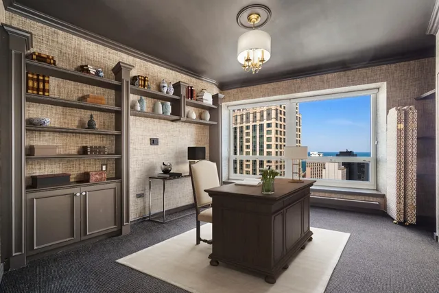 a room with stainless steel appliances kitchen island granite countertop a sink and cabinets