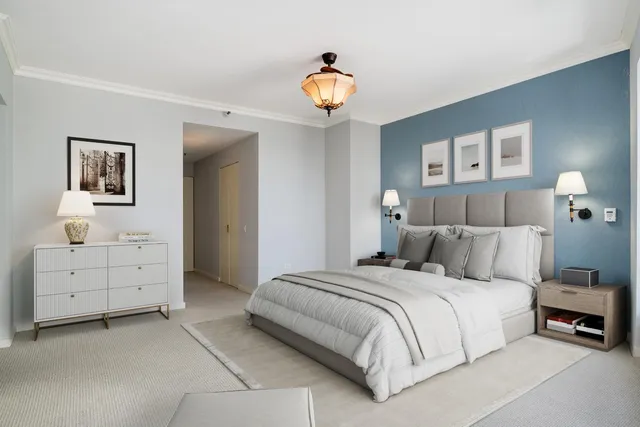 a bedroom with a bed and a chandelier