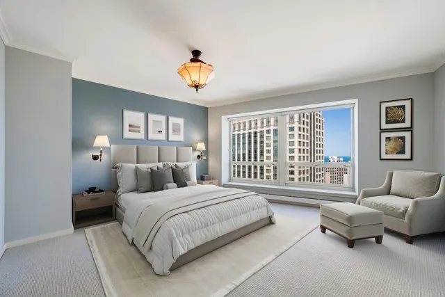 a bedroom with a bed couch and a window