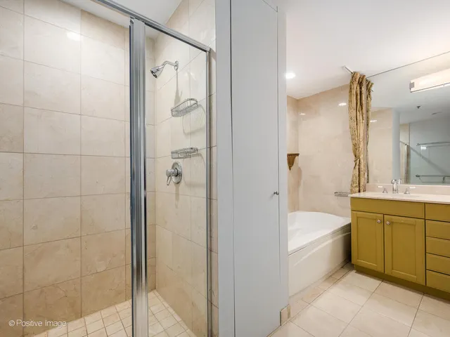 a bathroom with a tub a sink and mirrors