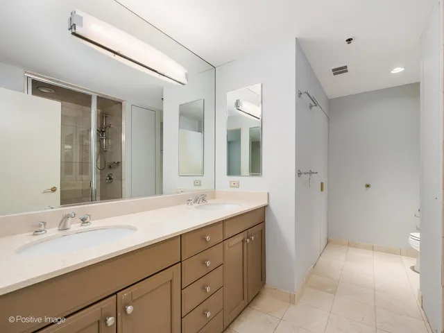 a spacious bathroom with a double vanity sink mirror and