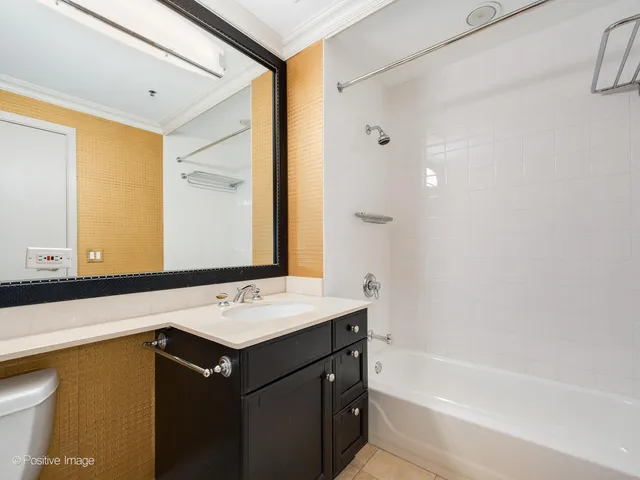 a bathroom with a sink vanity tub and a mirror