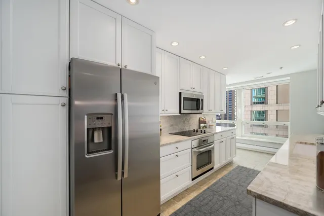 a kitchen with stainless steel appliances a refrigerator sink and microwave