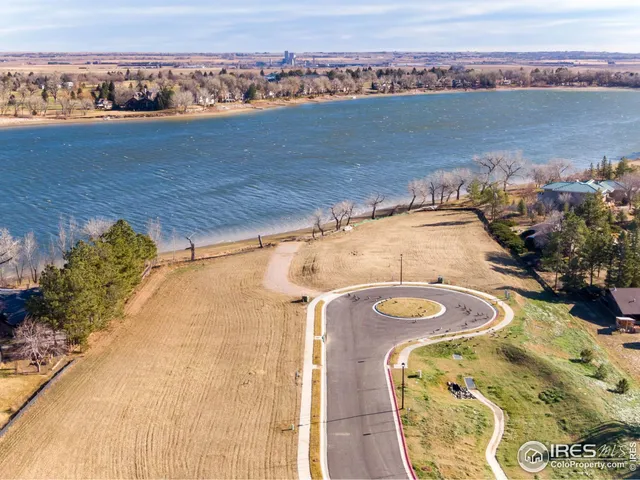 an aerial view of a house with a lake view
