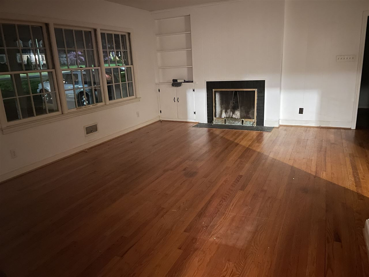 2116 10th Avenue Raleigh, NC 27607 - Photo 2 of 5 an empty room with wooden floor and windows
