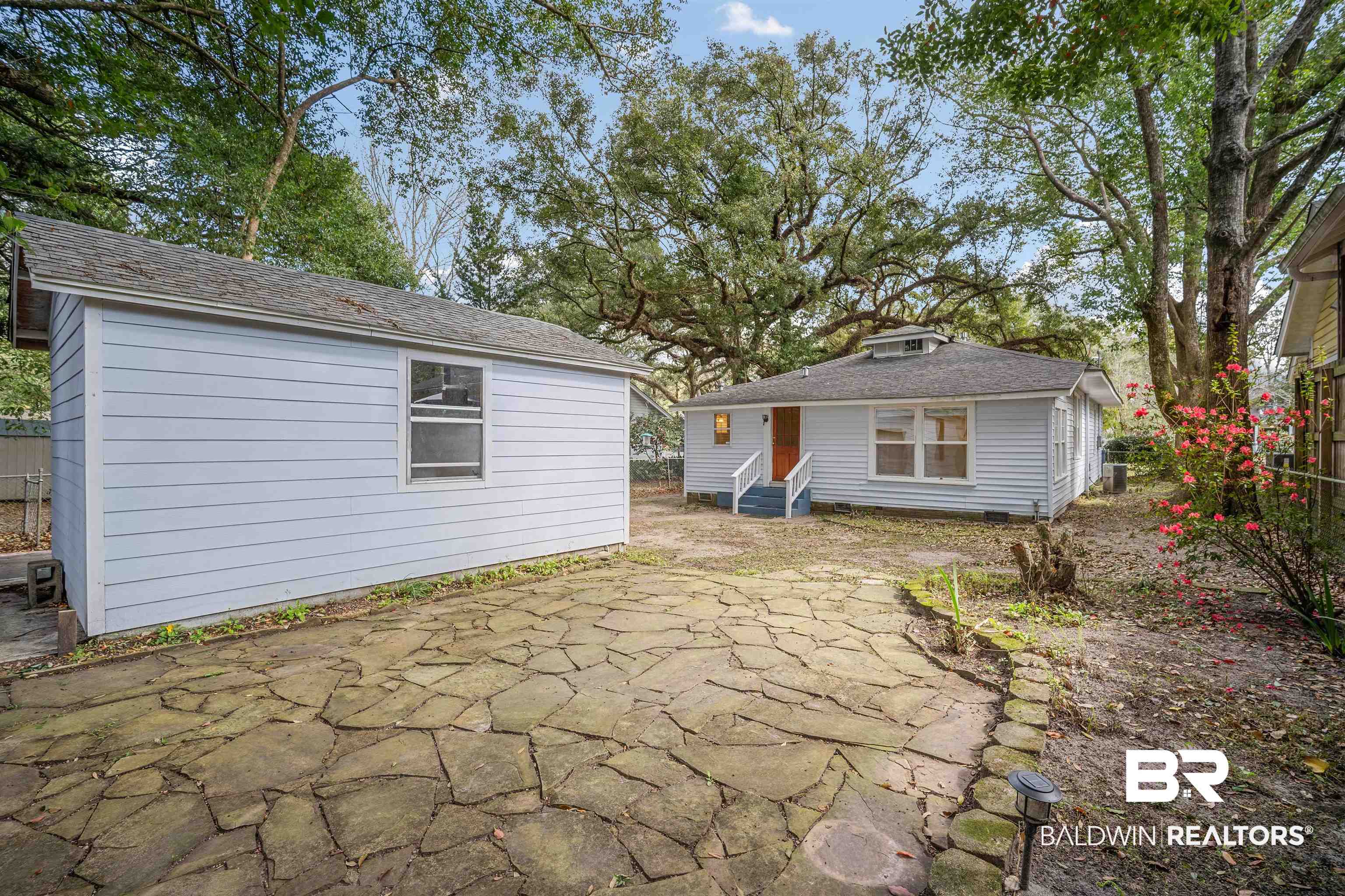 118 Mohawk Street Mobile, AL 36606 - Photo 24 of 26 Back of house featuring a patio, an outbuilding, entry steps, and a shingled roof