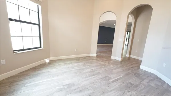 a utility room with cabinets and wooden floor