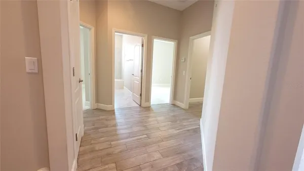 an empty room with a ceiling fan and carpet