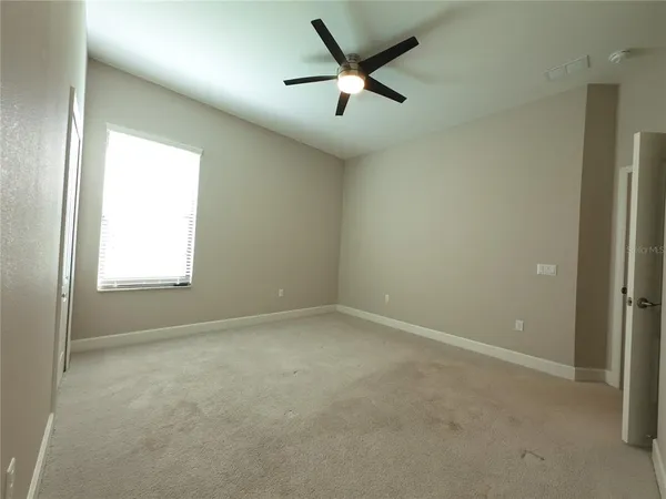 a large kitchen with kitchen island a large counter top space a sink stainless steel appliances and cabinets