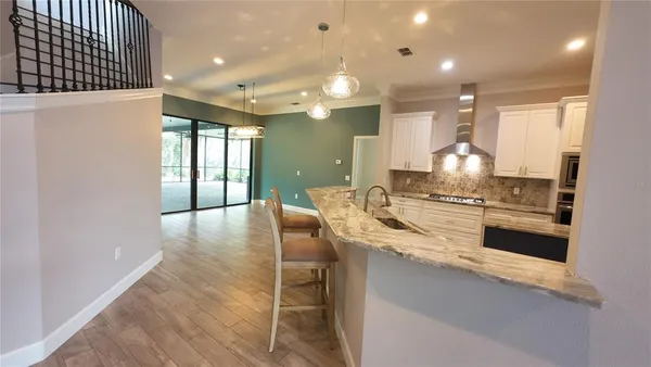 en empty room with windows and ceiling fan