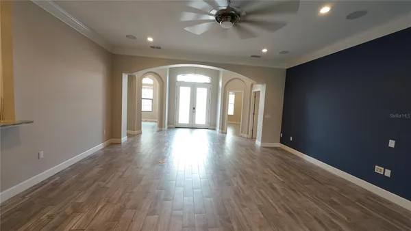 a view of a livingroom with a ceiling fan and window