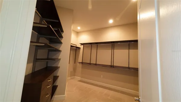 a view of empty room with wooden floor and windows