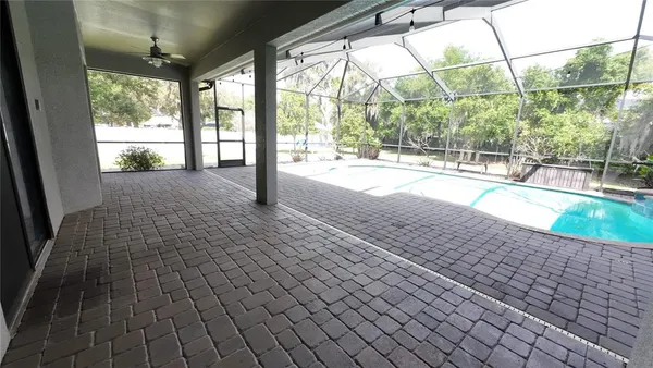 a view of a house with palm trees and a big yard