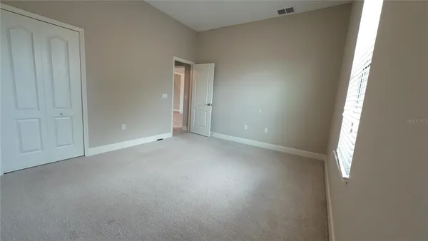 an empty room with windows and entrance