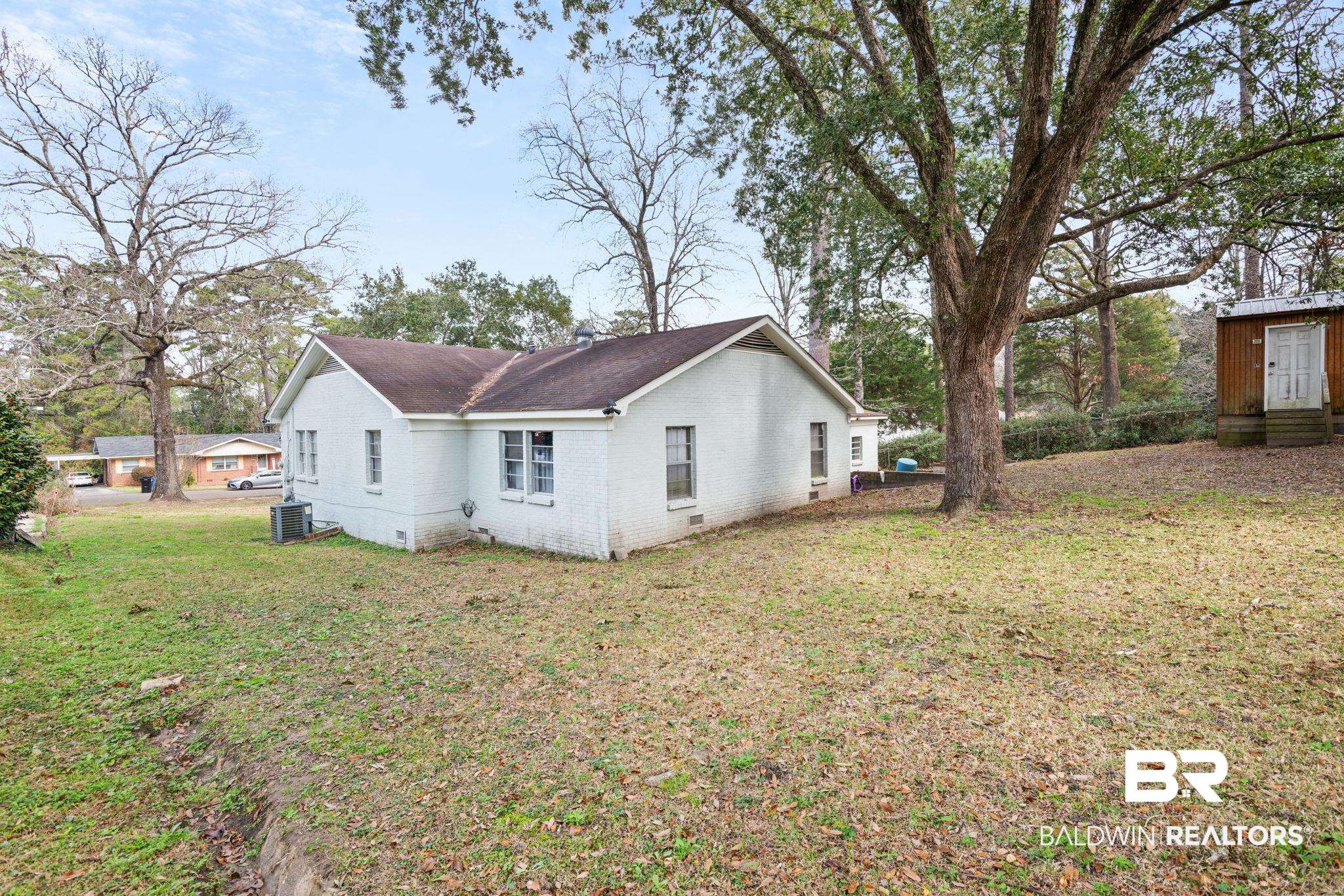 305 Alpine Street Mobile, AL 36611 - Photo 20 of 21 Back of property featuring a yard and central AC