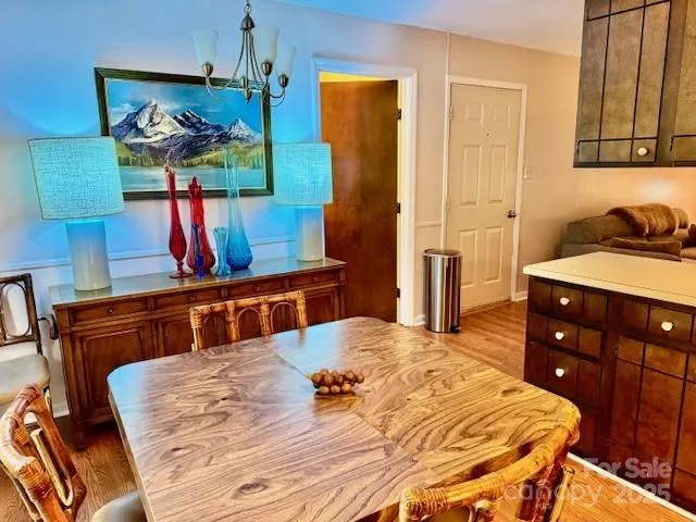 a bedroom with a bed and dresser with mirror