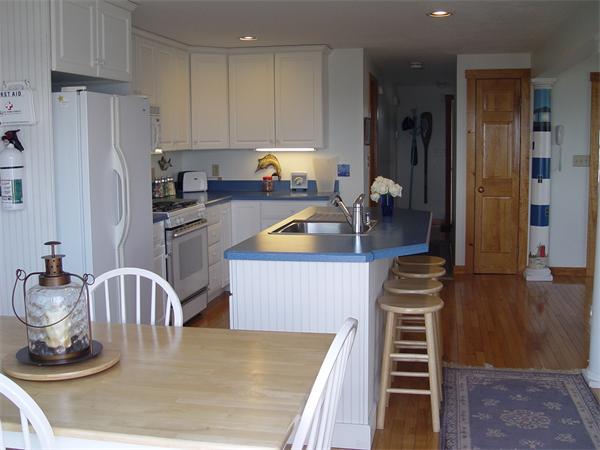 69 Ocean Road North Duxbury, MA 02332 - Photo 9 of 15 a kitchen with a refrigerator and a stove top oven