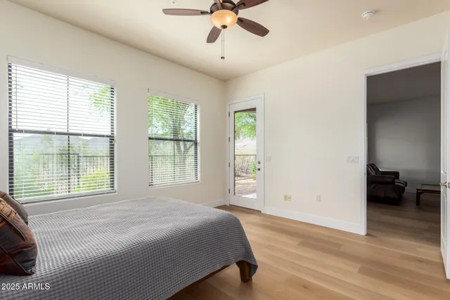 a bedroom with a large bed and a potted plant