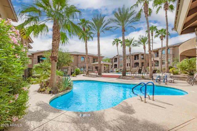 a view of a house with swimming pool with a lounge chair