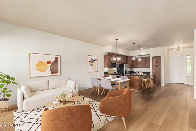 a kitchen with stainless steel appliances granite countertop a stove a refrigerator a sink a microwave and wooden floor