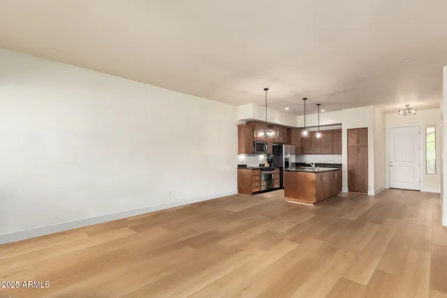 a living room with lots of furniture and kitchen view